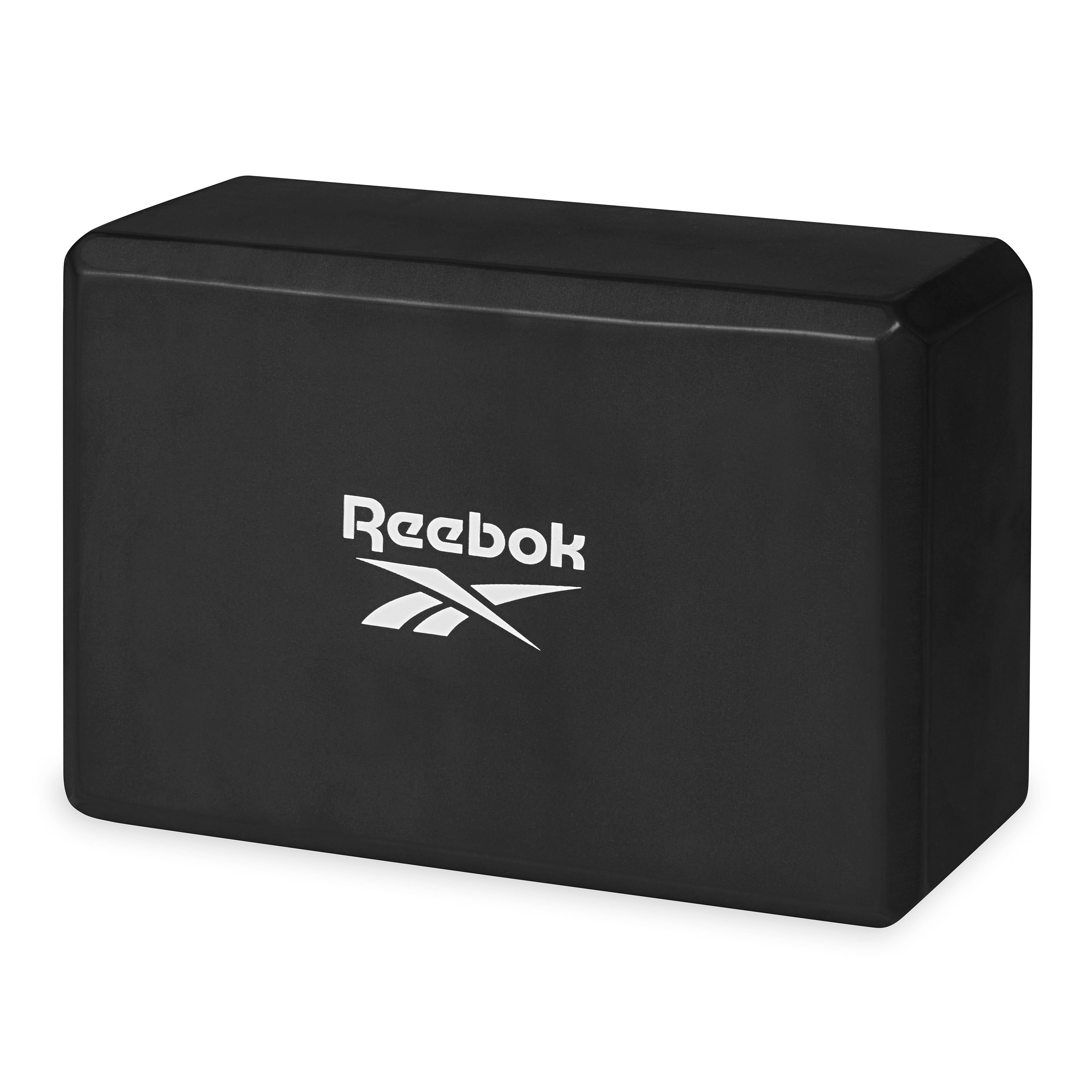 Black Reebok yoga block on a white background