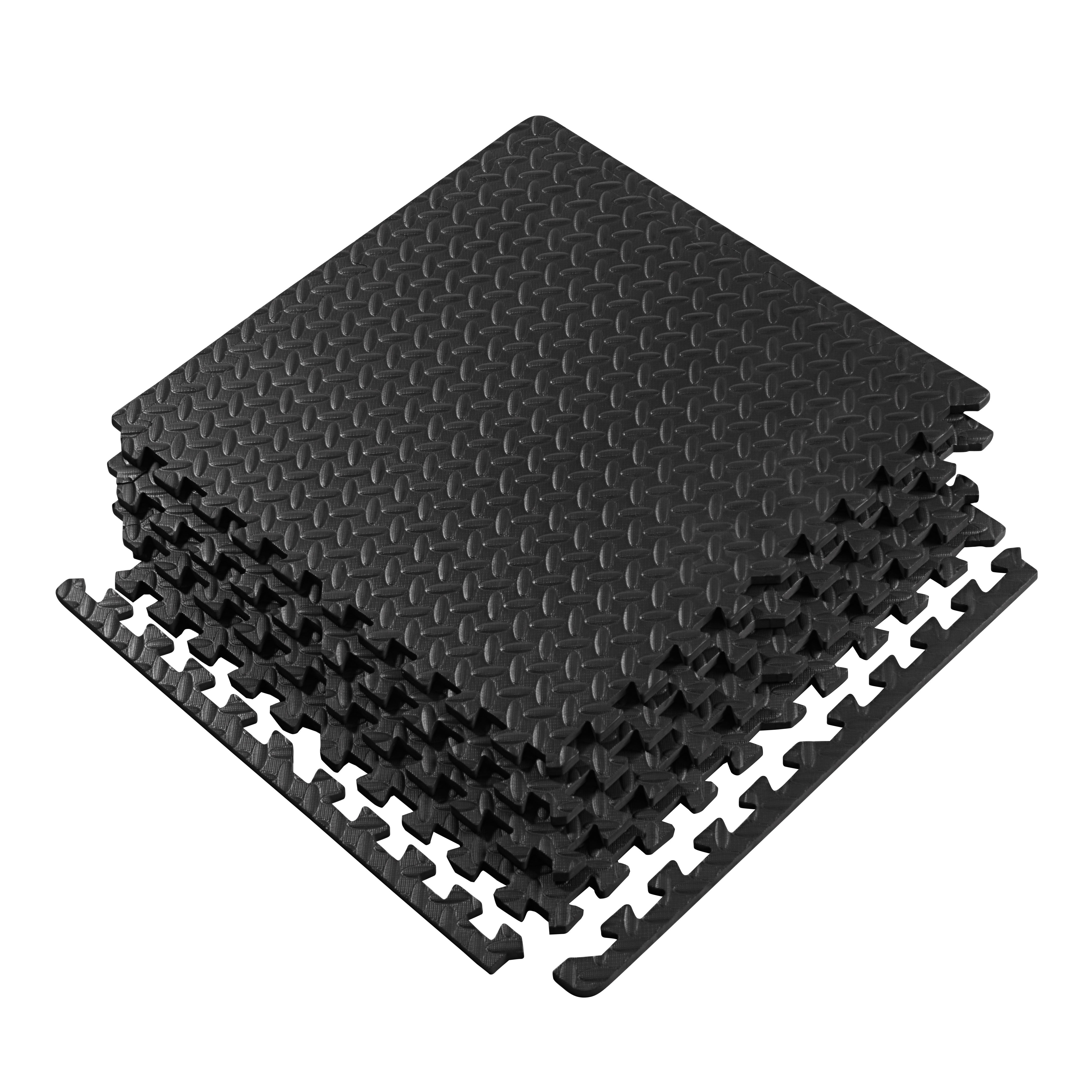 Stack of black interlocking foam mats on a white background
